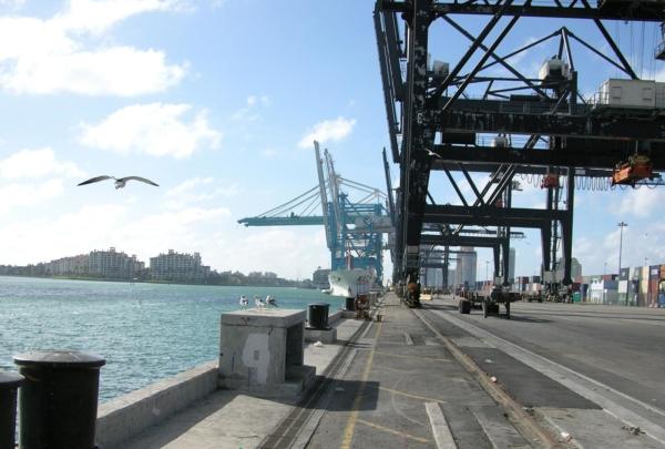 Photo of Port of Miami. Cargo side of the port. Container loaders.